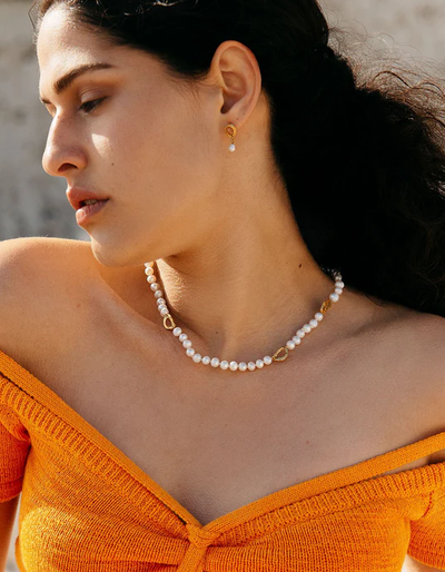 A woman wearing Loveness Lee dio aurum recycled silver earrings