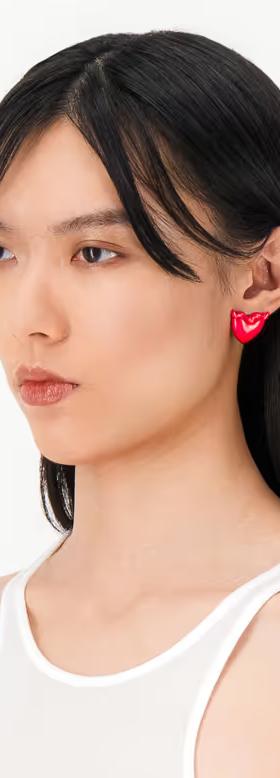 A woman wearing Justine Clenquet devil red earrings