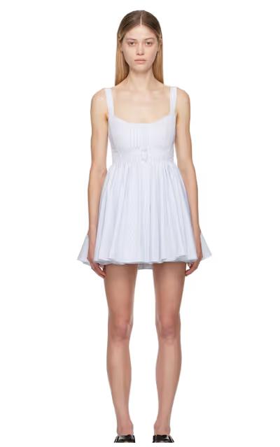 A woman wearing ALAÏA white & blue skater minidress
