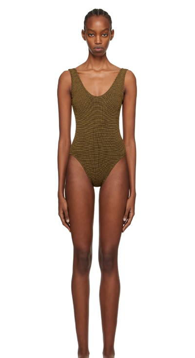 A woman wearing BOND-EYE brown mara swimsuit
