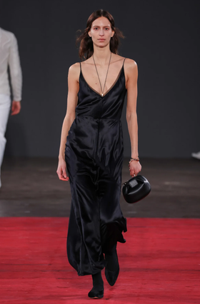 A woman wearing Gabriela Hearst brigita dress in black silk velvet