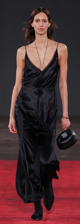 A woman wearing Gabriela Hearst brigita dress in black silk velvet