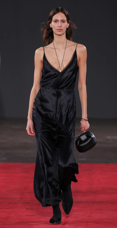 A woman wearing Gabriela Hearst brigita dress in black silk velvet
