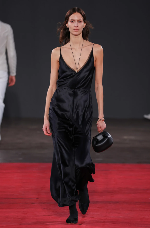 A woman wearing Gabriela Hearst brigita dress in black silk velvet