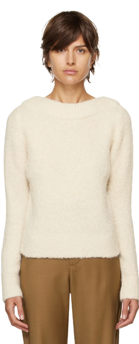 A woman wearing CO off-white boat neck sweater