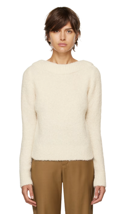 A woman wearing CO off-white boat neck sweater