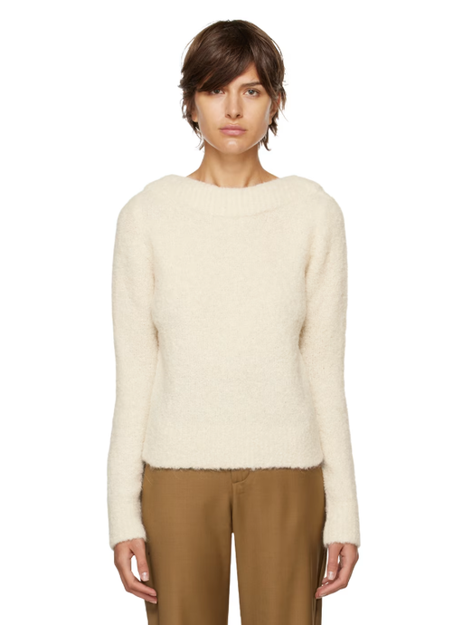 A woman wearing CO off-white boat neck sweater