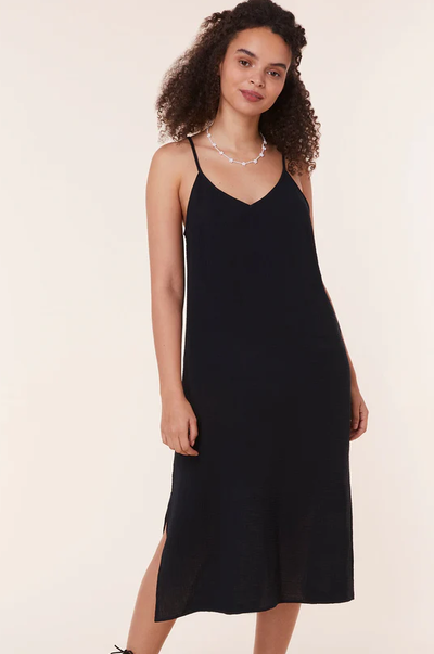 A woman wearing Andie black the barreta dress