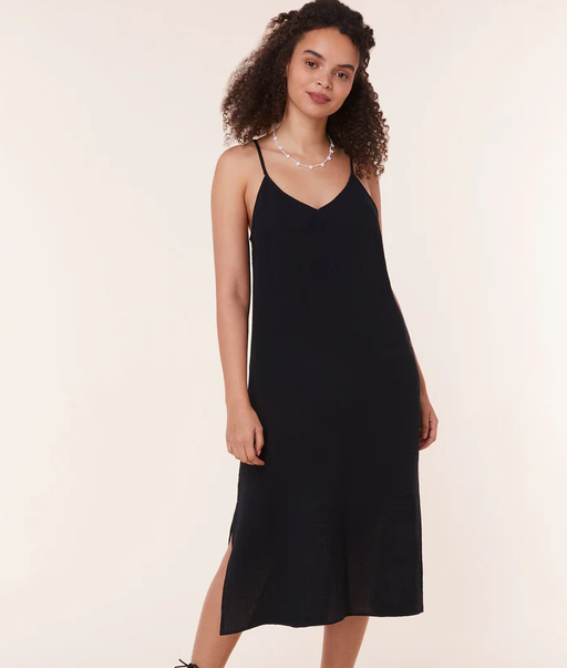 A woman wearing Andie black the barreta dress