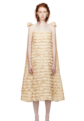 A woman wearing CAWLEY off-white bells maxi dress