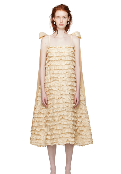 A woman wearing CAWLEY off-white bells maxi dress