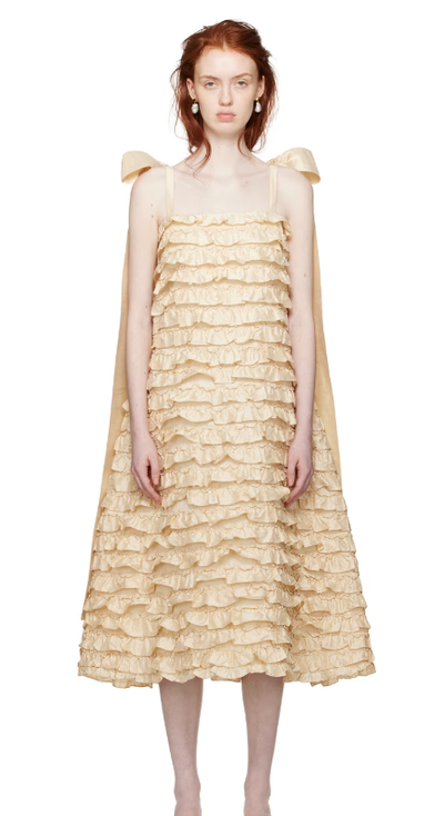 A woman wearing CAWLEY off-white bells maxi dress