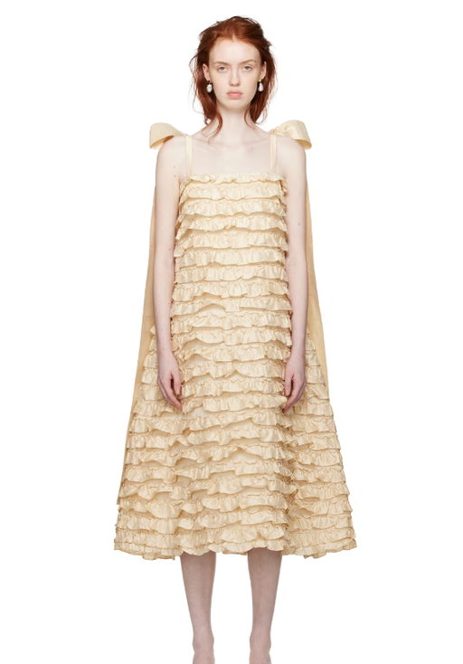 A woman wearing CAWLEY off-white bells maxi dress