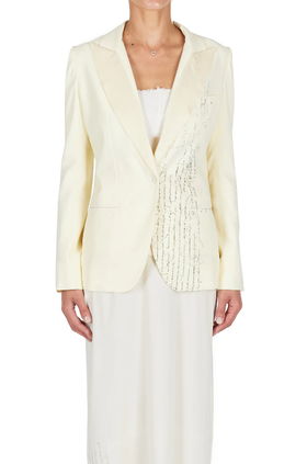 A woman wearing ecru color Carol Christian Poell closed tuxedo jacket