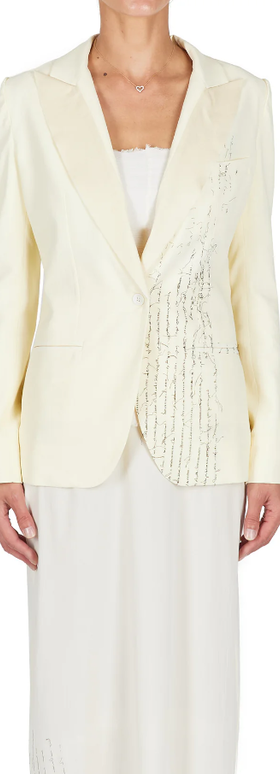 A woman wearing ecru color Carol Christian Poell closed tuxedo jacket