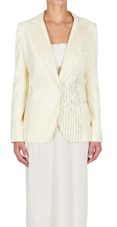 A woman wearing ecru color Carol Christian Poell closed tuxedo jacket
