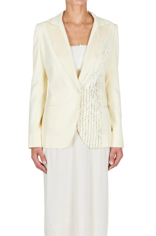 A woman wearing ecru color Carol Christian Poell closed tuxedo jacket