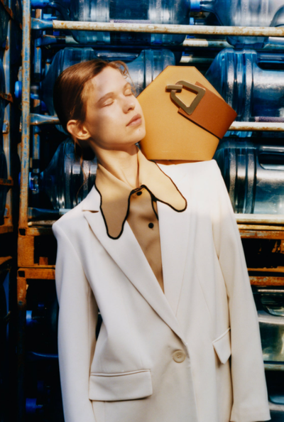 A woman carrying Danse Lente mini johnny bucket bag - light brown
