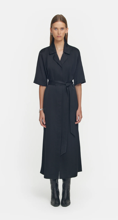 A woman wearing Viktoria & Woods black juilliard shirt dress
