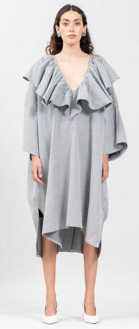 A woman wearing Botanica Workshop victoria dress in indigo stripes