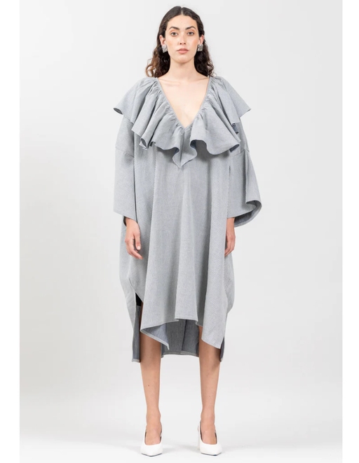 A woman wearing Botanica Workshop victoria dress in indigo stripes