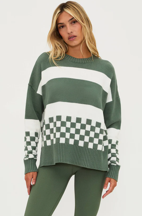 A woman wearing Beach Riot callie sweater olive check
