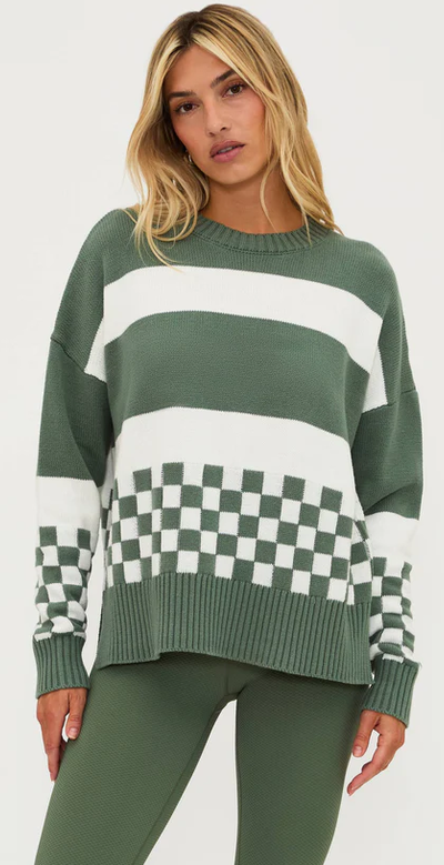 A woman wearing Beach Riot callie sweater olive check