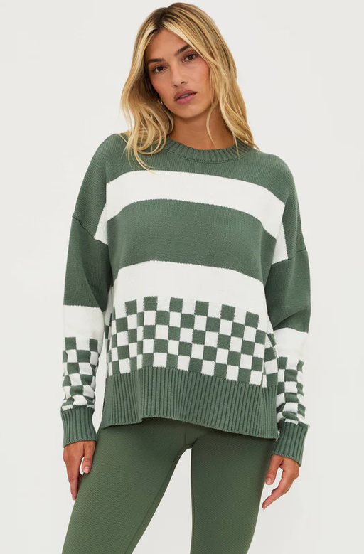 A woman wearing Beach Riot callie sweater olive check
