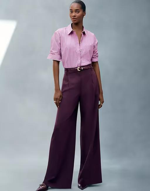 A woman wearing Ann Taylor pink stripe oversized shirt