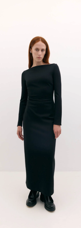A woman wearing Harris Tapper long sleeve bea dress