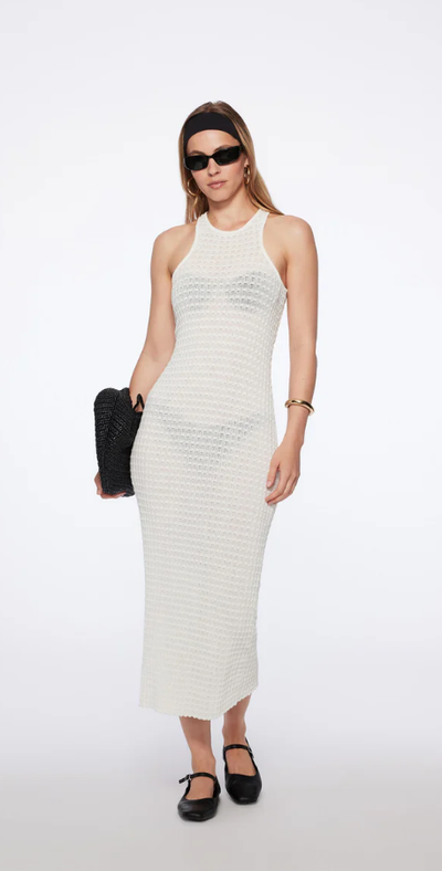 A woman wearing TROPIC OF C nero dress in white