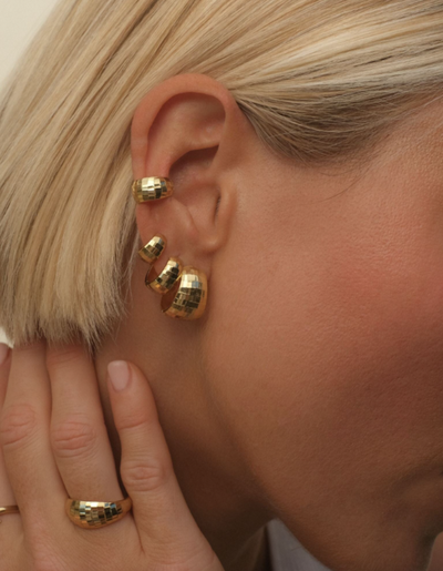 A woman wearing Adornmonde hank bold disco hoop earrings