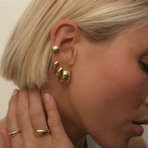 A woman wearing Adornmonde hank bold disco hoop earrings