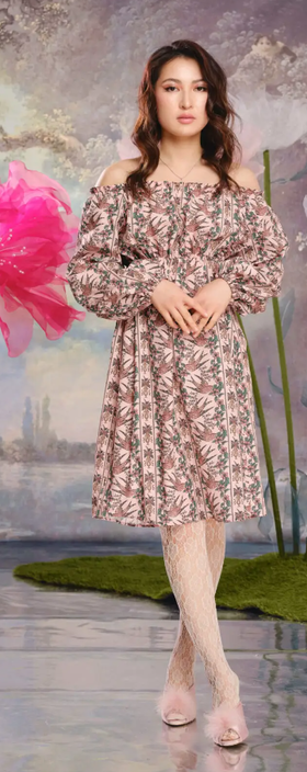 A woman wearing Loud Bodies “alice” dress pink swallows tencel