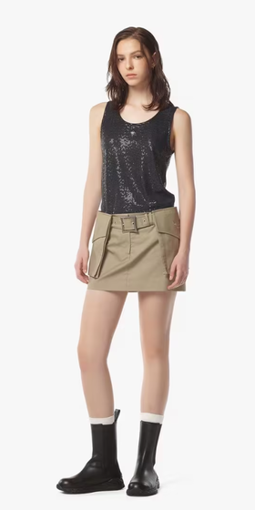 A woman wearing MCM beige gabardine skirt w/ detachable pocket belt