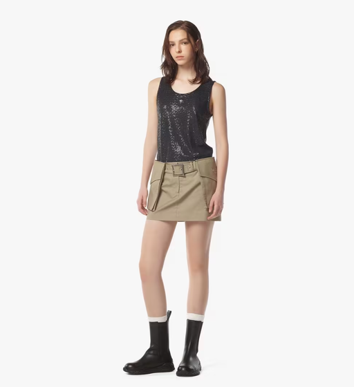 A woman wearing MCM beige gabardine skirt w/ detachable pocket belt