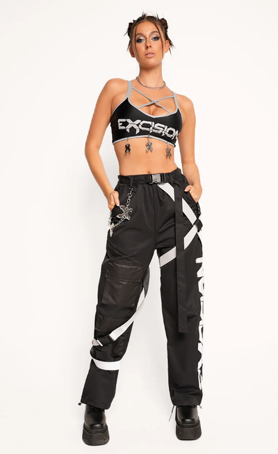 A woman wearing excision x iheartraves charged up reflective wire top
