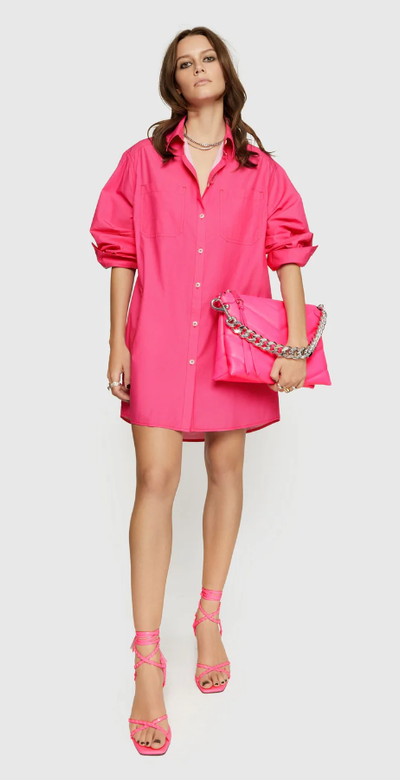A woman wearing Rebecca Minkoff hot pink tori dress