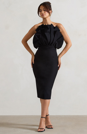 A woman wearing Club L black ruffled strapless midi dress