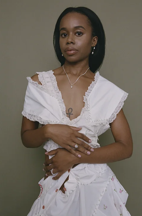 A woman wearing Yam space bar earrings