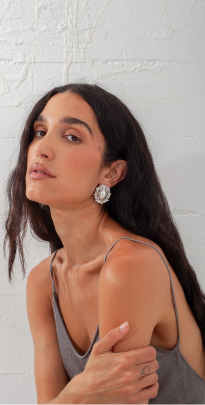 A woman wearing Above Average Studio reine earrings - silver