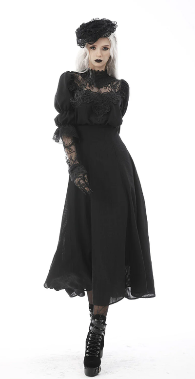 A woman wearing Vampire Freaks black spirits past maxi dress