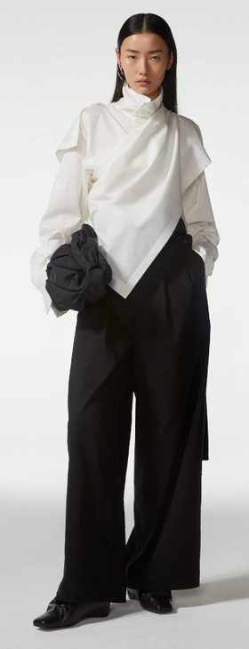 A woman wearing Bao Bao white top and black pant