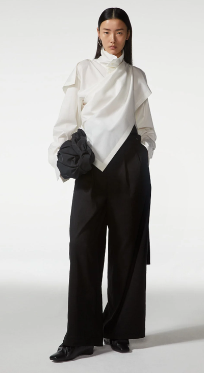 A woman wearing Bao Bao white top and black pant