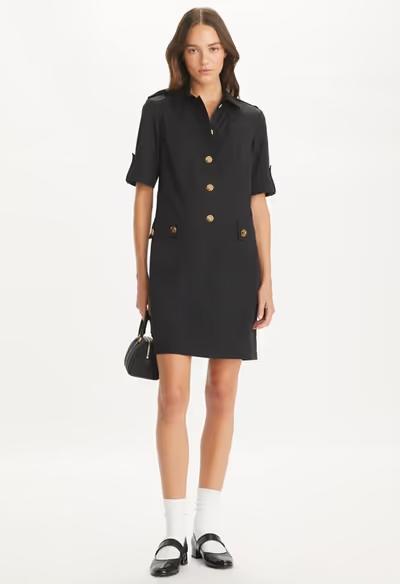 A woman wearing Tory Burch black camp dress