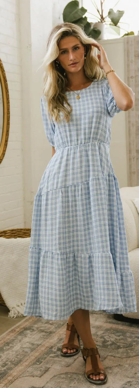 A woman wearing Böhme melina plaid midi dress in blue