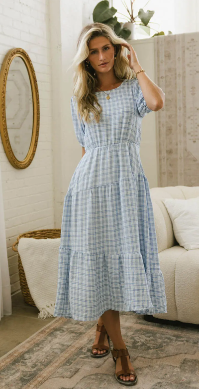 A woman wearing Böhme melina plaid midi dress in blue