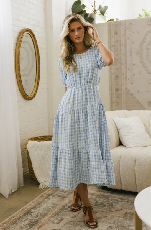 A woman wearing Böhme melina plaid midi dress in blue