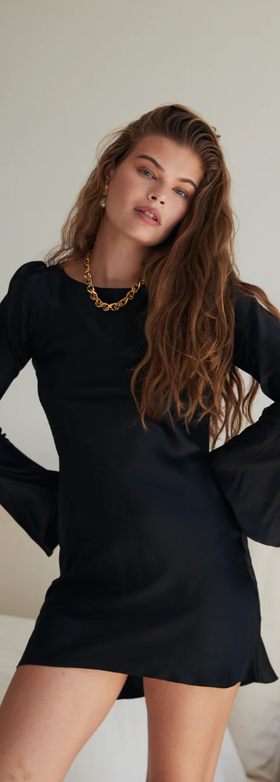 A woman wearing Stone Cold Fox basier dress black