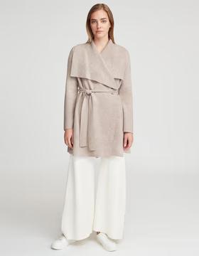 A woman wearing Cuyana wool cashmere sweater coat